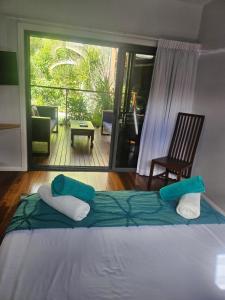 a bed in a room with a view of a patio at Windspray in Horseshoe Bay