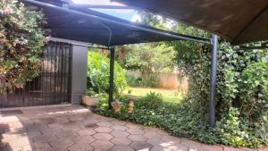 a large blue umbrella over a patio at J & M Elegant Escape in Centurion
