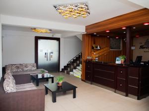a lobby with a couch and a table and stairs at Heritage Grand - Badulla in Badulla