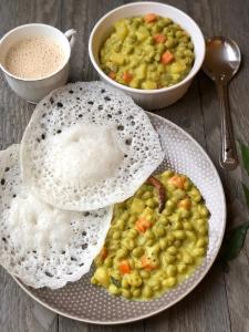 a plate of food with rice and a bowl of peas at Ferns n' Falls in Chinnakanal