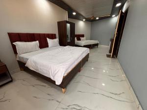 Postel nebo postele na pokoji v ubytování Dharohar Homestay Chandrabhaga