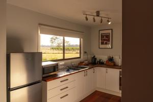 a kitchen with a stainless steel refrigerator and a window at Moodemere Lake House in Rutherglen +34 photos