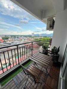 a balcony with two chairs and a wooden bench at G Home 3 - Ipoh City Centre Majestic 2R2B in Ipoh