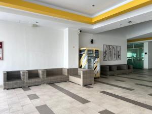 a lobby with couches and posters on the wall at G Home 3 - Ipoh City Centre Majestic 2R2B in Ipoh +48 photos
