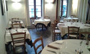 a dining room with tables and chairs with white tablecloths at La Sauldre in Vailly-sur-Sauldre