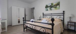 a bedroom with a black bed with white pillows at La Fattoria dei Desideri in Ripa Teatina