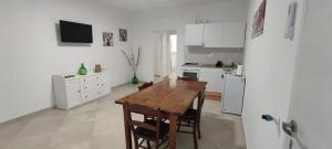 a kitchen with a wooden table and a refrigerator at La Fattoria dei Desideri in Ripa Teatina