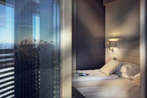 A bed or beds in a room at Brenta Dolomites