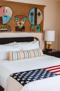 a white bed with an american flag on it at Graduate by Hilton Tempe in Tempe