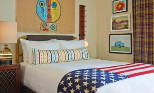 a bedroom with a bed with an american flag pillow at Graduate by Hilton Tempe in Tempe