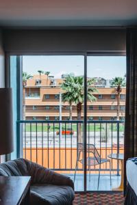 a living room with a couch and a view of a building at Graduate by Hilton Tempe in Tempe