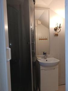 a bathroom with a sink and a mirror at Номер в Гостевом доме у моря in Odesa