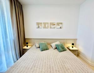 a bedroom with a bed with two pillows on it at Seaside Luxury Apartment - Lozenetz in Lozenets +24 photos