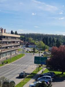 an empty street with cars parked in a parking lot at SoulPoint Lenti in Lenti