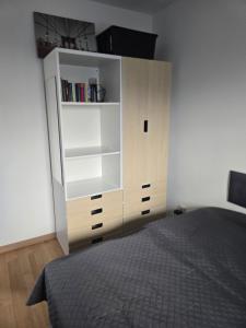 a bedroom with a white cabinet and a bed at Haus Dresden, Pool, Garten, Terrasse, familienfreundlich in Dresden +7 photos