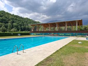 a large swimming pool with a building in the background at Can Vibru Vilallonga in Vilallonga de Ter