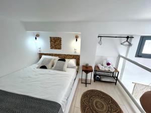 a bedroom with a bed and a balcony at Babatseratsi skyrian studio 1 in Skiros