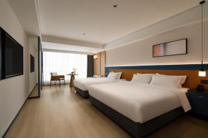 Postelja oz. postelje v sobi nastanitve Chongqing Jiefangbei Jiayu Hotel