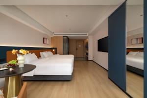 Postelja oz. postelje v sobi nastanitve Chongqing Jiefangbei Jiayu Hotel