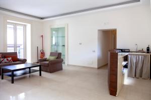 a living room with a couch and a table and chairs at Opera 5 in Naples