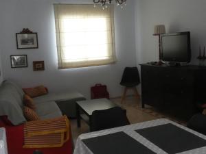 a living room with a couch and a tv at Casa Ledo in Casas de Don Antonio