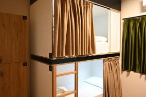 a room with a bunk bed with a mirror at Top view hostel in Durrës