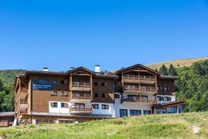 a building on the side of a hill at CGH Résidence Boutique La Grange aux Fées in Valmorel