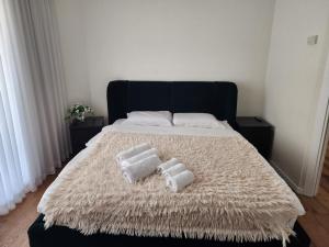 a bed with two pillows on top of it at תמר על הים in Bat Yam +17 photos