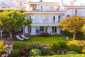 a view of a house with a yard at Exclusive Mediterranean Panorama in Sant Pol de Mar in San Pol de Mar