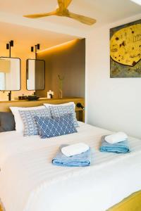 a bedroom with a bed with two towels on it at Exclusive Mediterranean Panorama in Sant Pol de Mar in San Pol de Mar