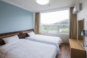 Postel nebo postele na pokoji v ubytování Kumho Hwasun Spa Resort + 16 fotografií