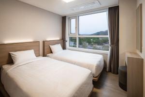 Postel nebo postele na pokoji v ubytování Kumho Hwasun Spa Resort