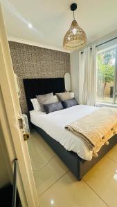 a bedroom with a large bed and a window at Hideaway Haven 2 in Cape Town