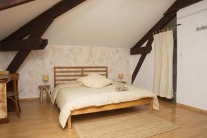 a bedroom with a bed in a attic at Auberge de Lagrand in Lagrand