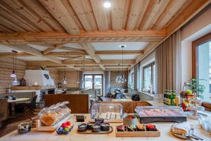 a large kitchen with wooden ceilings and wooden counters at ESCHENHOF - Bed & Breakfast in Kaprun