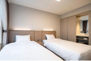 Postel nebo postele na pokoji v ubytování Kumho Hwasun Spa Resort