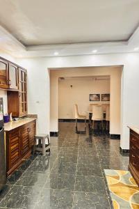 a kitchen with a table and chairs in a room at A private room in,Coastal Bliss homestsy in Mombasa