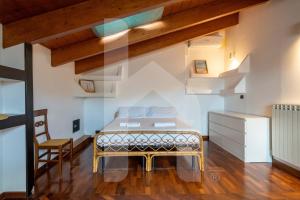 a bedroom with a bed in a room with wooden ceilings at Homiday - Palazzo Passerini in Pineto