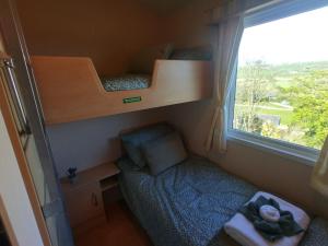 سرير أو أسرّة في غرفة في Seaside chalet in Ardmore with breathtaking views