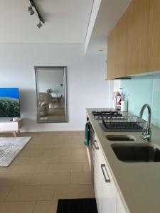 a kitchen with a sink and a counter top at Waterfront Getaway Darwin City in Darwin