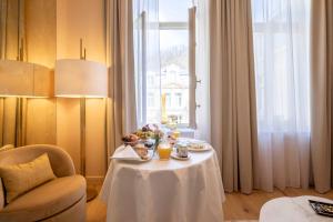 a table with food on it in a room with a window at Les Bains de Spa in Spa