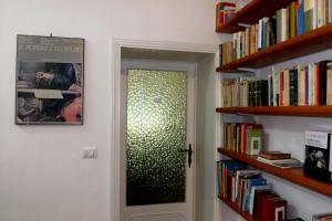 a door in a room with bookshelves at B&B dei Filosofi Bed and Breakfast in Perugia