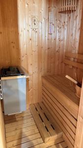 a small wooden sauna with a stove in it at Veranda by Welcome Hua Hin in Hua Hin