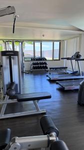 a gym with several treadmills and machines in it at Veranda by Welcome Hua Hin in Hua Hin