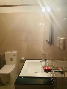 a bathroom with a toilet and a sink at Coastal Heaven in Bentota