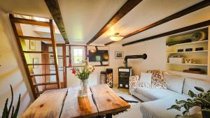 a living room with a table and a couch at Wöschhüsli mit Sauna, Alpenruhe nahe Bodensee in Rheineck