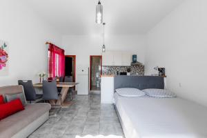 a living room with a bed and a kitchen at Apartments Papic in Vrsi +65 photos