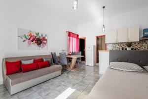 a living room with a couch and a table at Apartments Papic in Vrsi