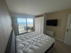 ein Schlafzimmer mit einem Bett mit Blick auf den Strand in der Unterkunft L'air Marin Clim&Parking in Sète + 5 Fotos