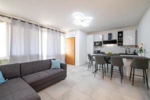 a living room with a couch and a kitchen at Apartment24 in Colle di Val d'Elsa